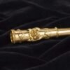 Close-up of hand-engraved rose motif on gold cigarette holder