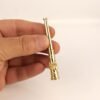 Ornate gold vintage cigarette holder held in hand — Hover Jewelry luxury smoking accessory