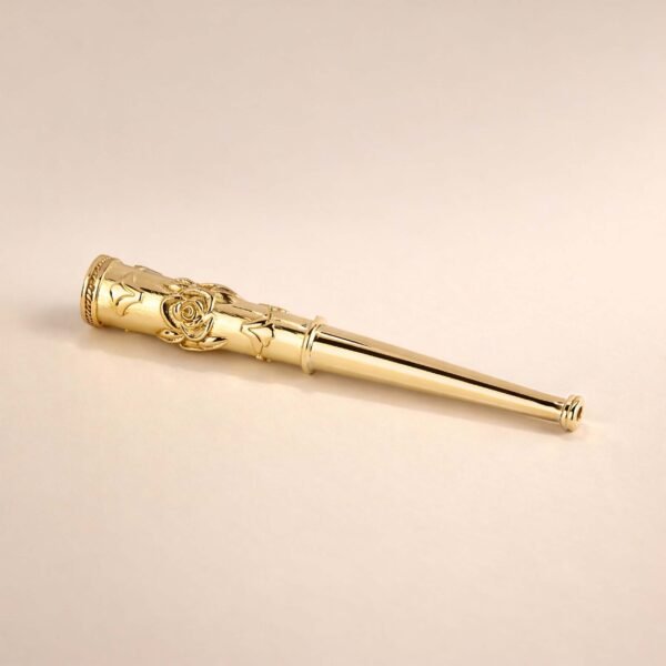 Close-up of hand-engraved rose motif on gold cigarette holder